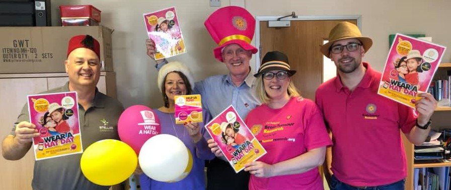 Tim Green of Brain Tumour Reseach Visits Clarity Care Consulting Offices to receive money from Lynn Osborne for Wear A Hat Day 2019